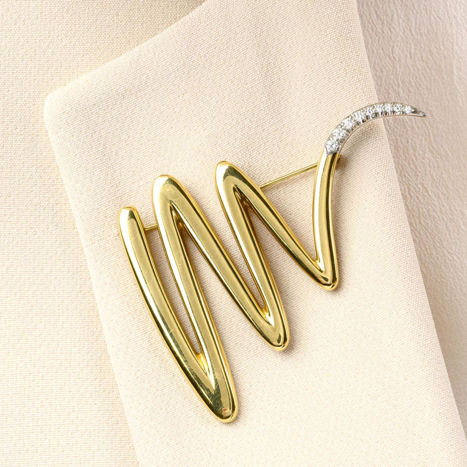 A brilliant-cut diamond terminal squiggle brooch,