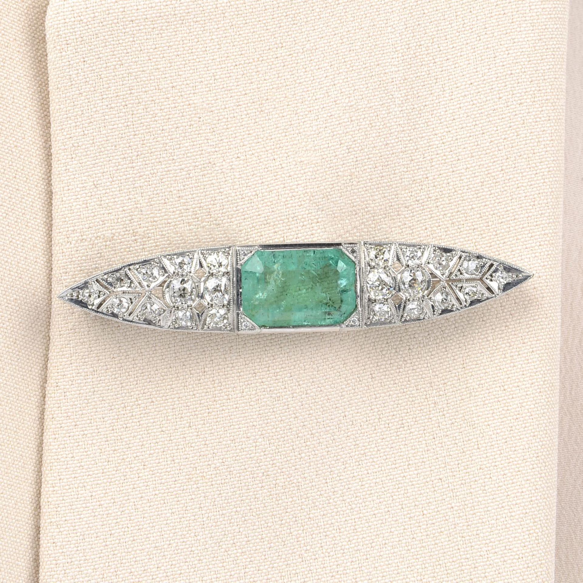 A mid 20th century 18ct gold emerald and old-cut diamond brooch.Emerald calculated weight 4.69cts,