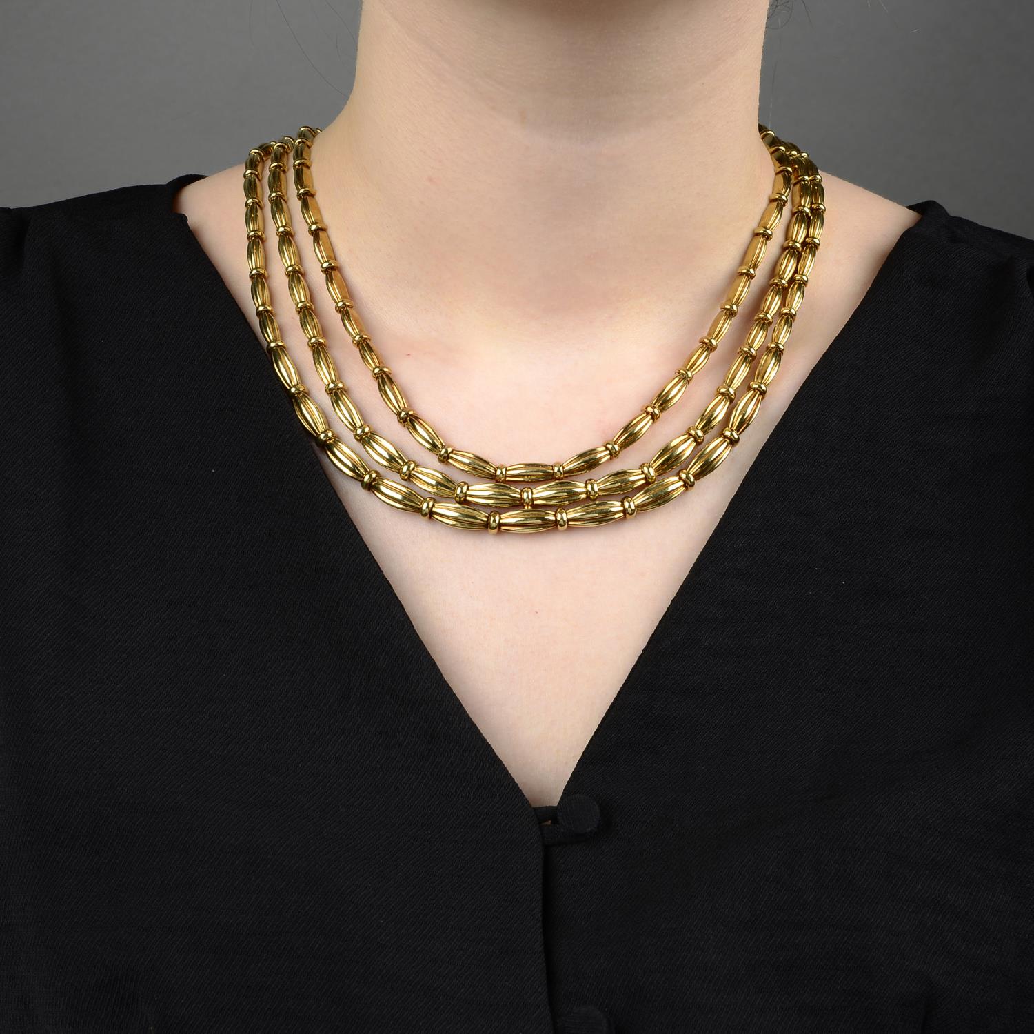 A grooved link, three-strand necklace, by Tiffany & Co.Stamped 750. - Image 5 of 5