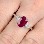 A ruby and pear-shape diamond three-stone ring.