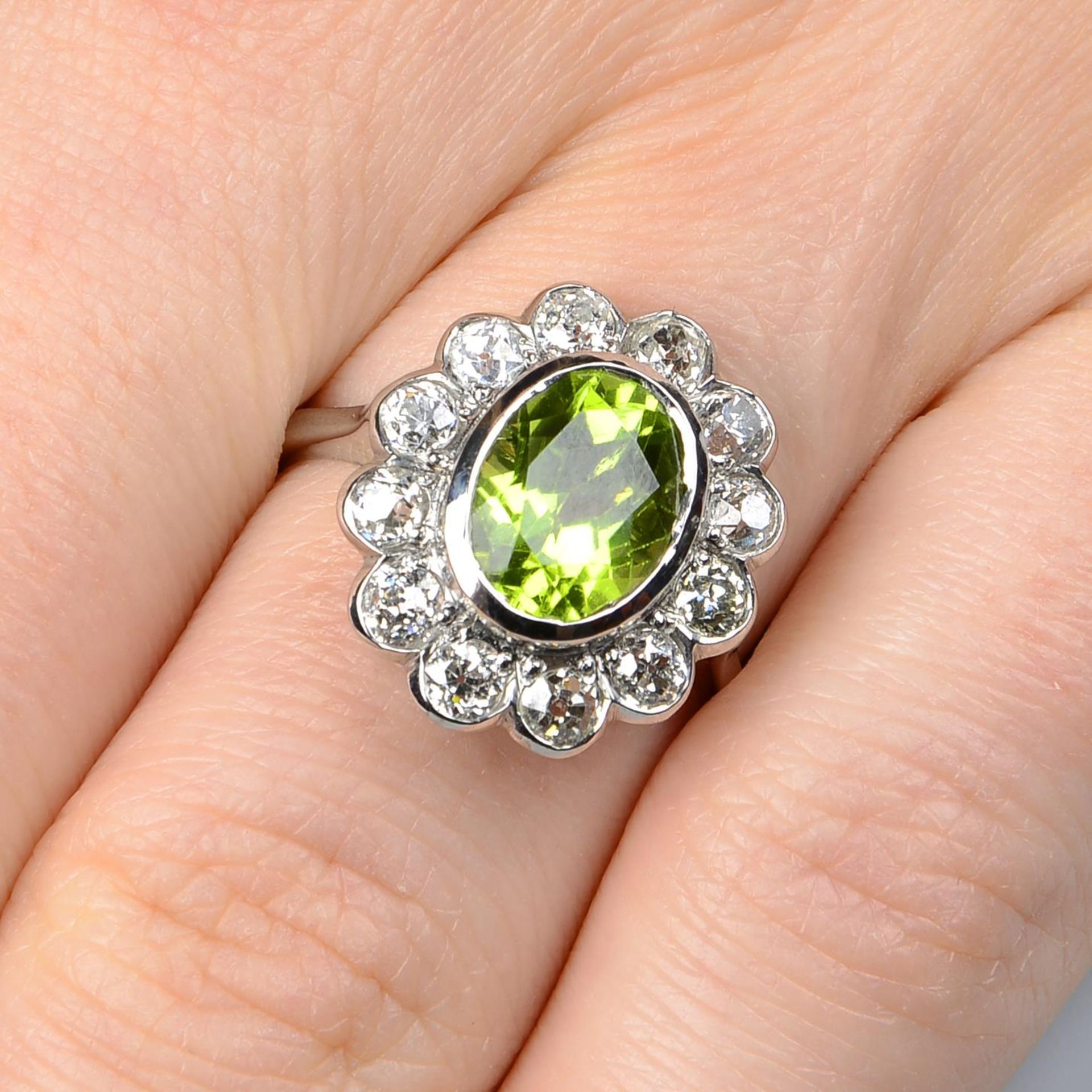 A peridot and old-cut diamond floral cluster ring.