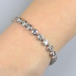 A brilliant-cut diamond collet line bracelet.