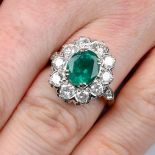 An emerald and brilliant-cut diamond cluster ring.