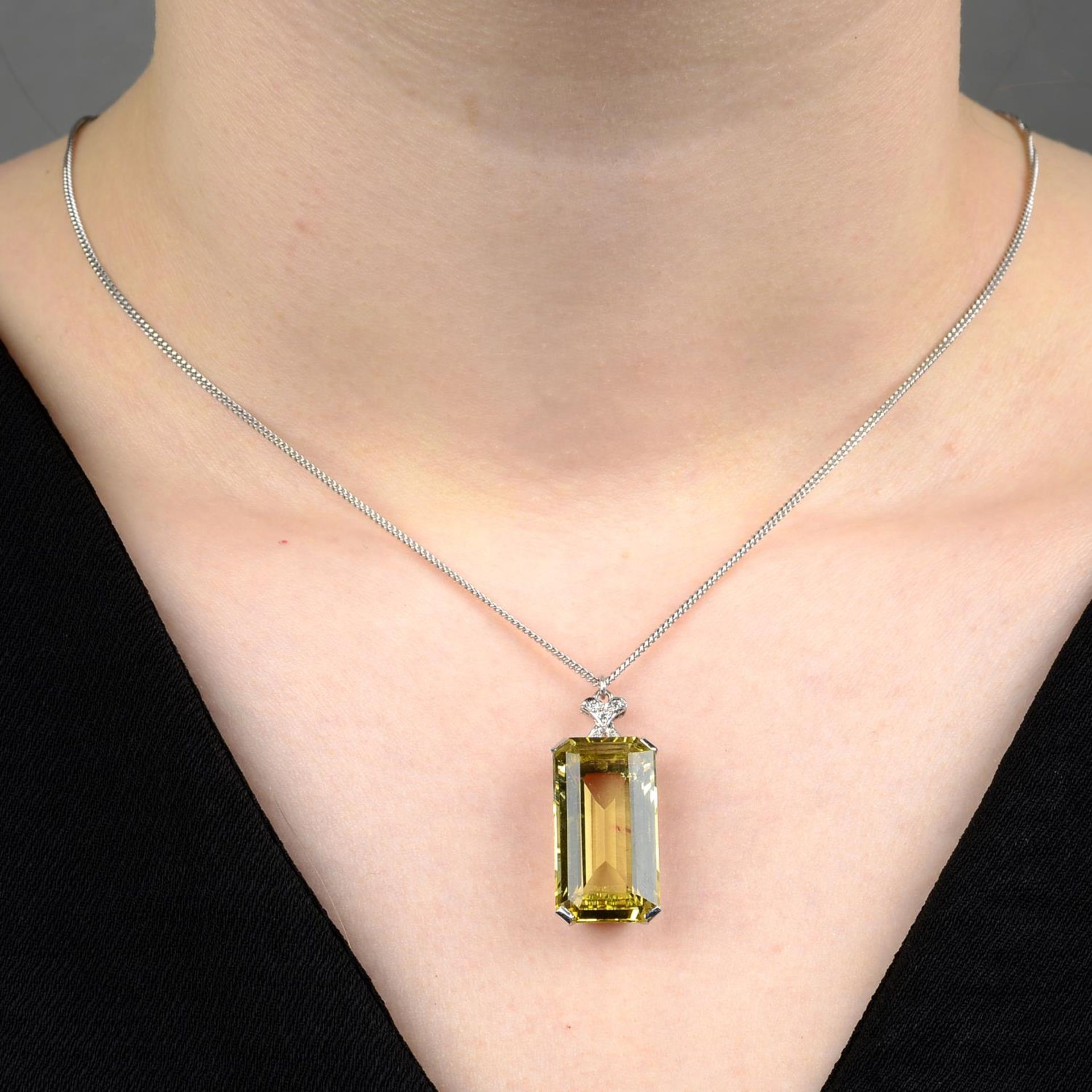 A heliodor and diamond pendant, on chain.