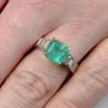 An 18ct gold emerald single-stone ring, with baguette-cut diamond sides.