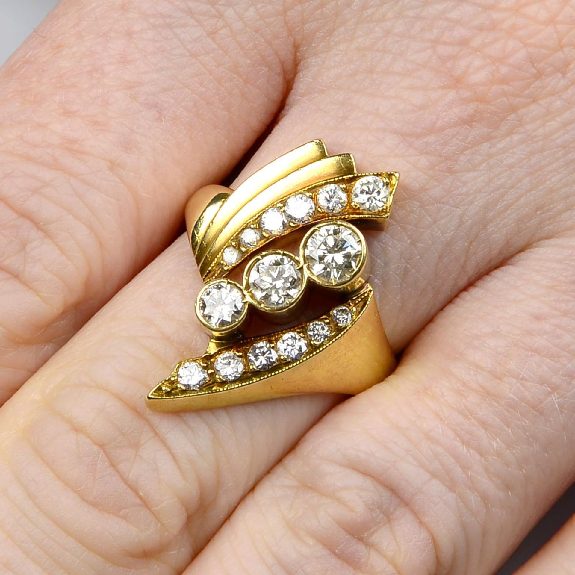 A brilliant-cut diamond crossover ring,