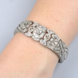 A diamond bracelet, with pierced scrolling design.