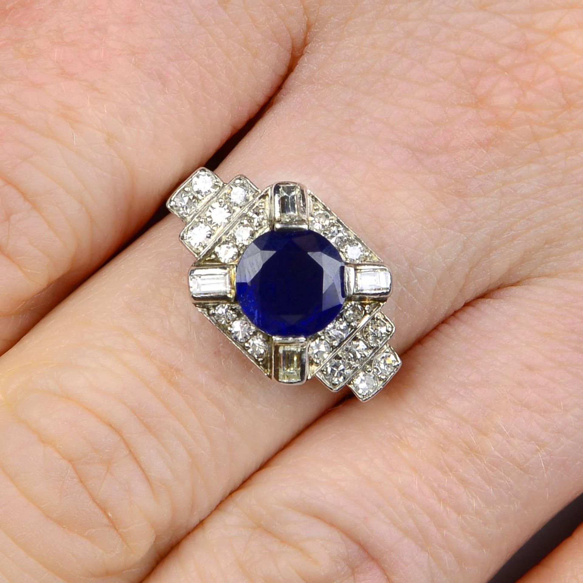 An Art Deco platinum sapphire and vari-cut diamond dress ring.Sapphire calculated weight 2.07cts,