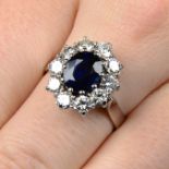 A sapphire and brilliant-cut diamond cluster ring.Sapphire calculated weight 3.01cts,