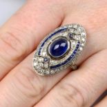 A sapphire and vari-cut diamond dress ring.Sapphire cabochon calculated weight 2.62cts,