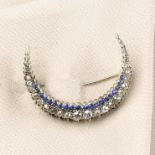 A graduated old-cut diamond and sapphire crescent brooch.Estimated total diamond weight 1.40cts,