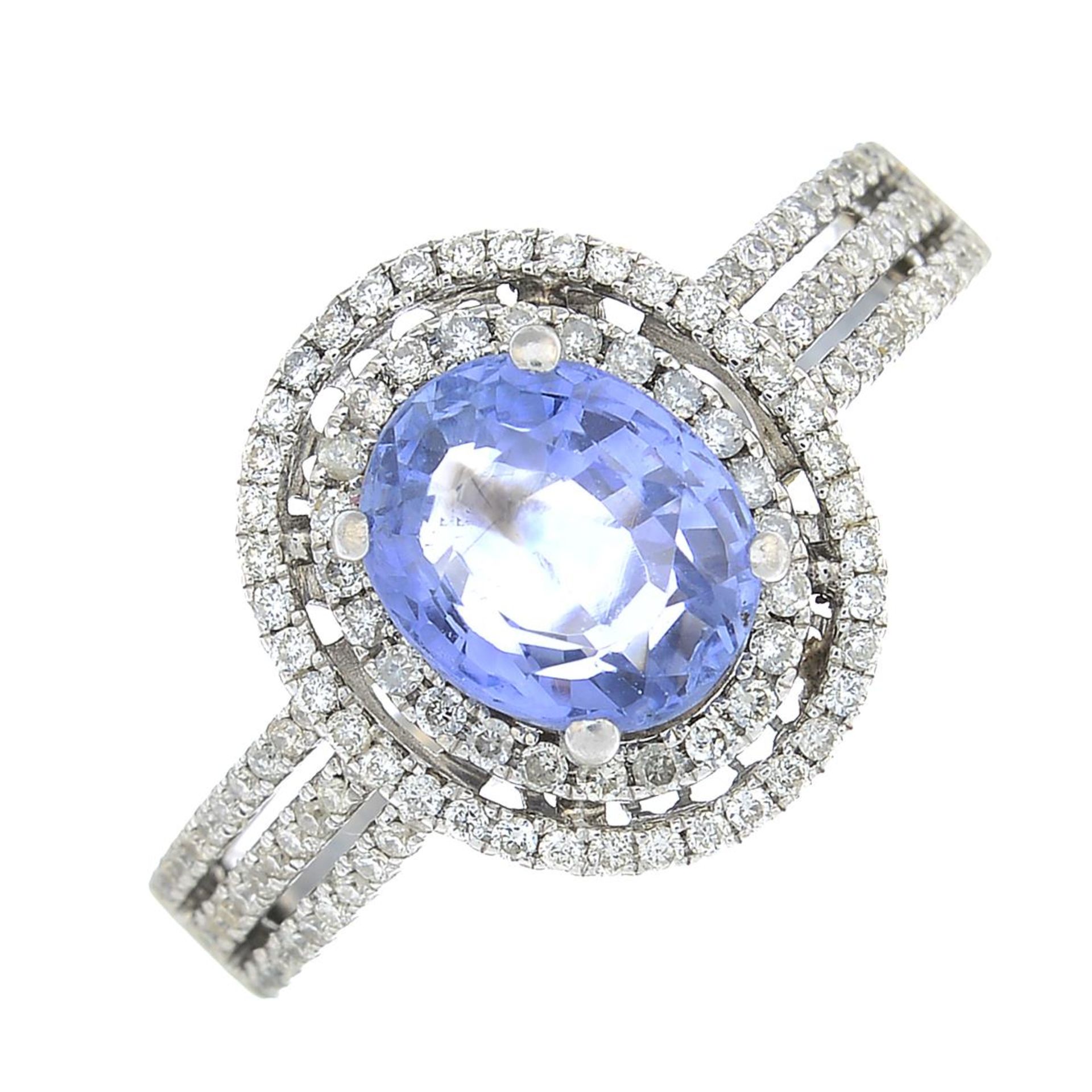 An oval-shape sapphire and brilliant-cut diamond cluster ring.Sapphire calculated weight 1.68cts,