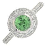 An 18ct gold circular-shape tsavorite garnet and brilliant-cut diamond cluster ring.Estimated total