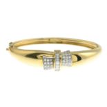 A baguette and pave-set diamond hinged bangle.Estimated total diamond weight 1ct,