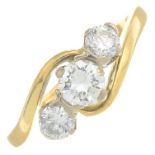 An 18ct gold brilliant-cut diamond three-stone crossover ring.Estimated total diamond weight