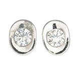 A pair of 18ct gold diamond single-stone stud earrings.Estimated total diamond weight 0.30ct,