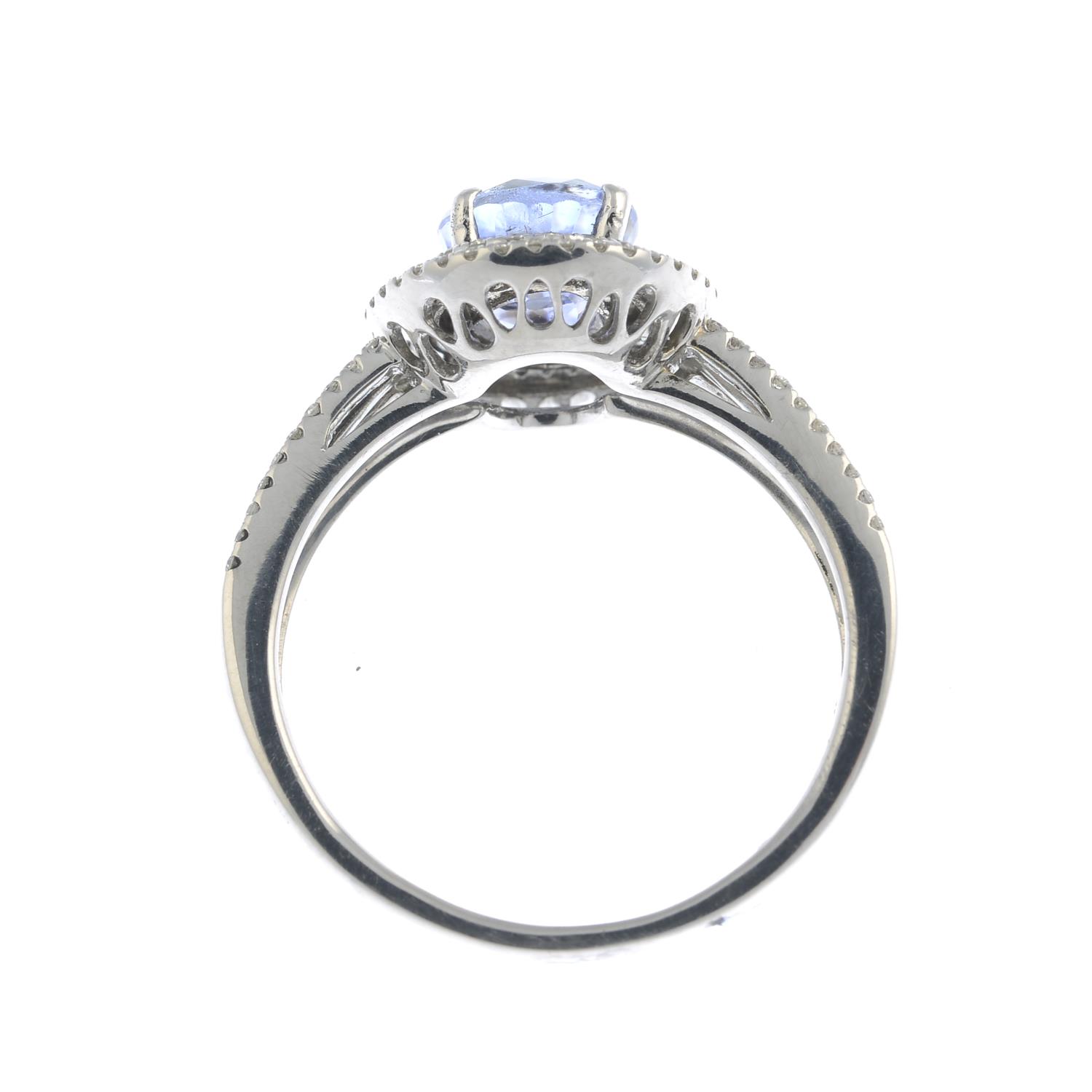 An oval-shape sapphire and brilliant-cut diamond cluster ring.Sapphire calculated weight 1.68cts, - Image 2 of 3