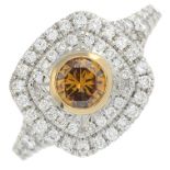 A brilliant-cut 'orangey-brown' diamond and diamond cluster ring.'Orangey-brown' diamond estimated