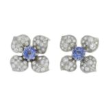 A pair of circular-shape sapphire and pave-set diamond floral earrings.Estimated total diamond