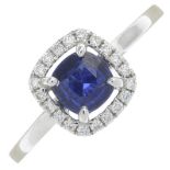 An 18ct gold cushion-shape sapphire and brilliant-cut diamond cluster ring.Sapphire weight