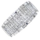 A dress ring, variously set with square-shape and baguette-cut diamonds.Estimated total diamond