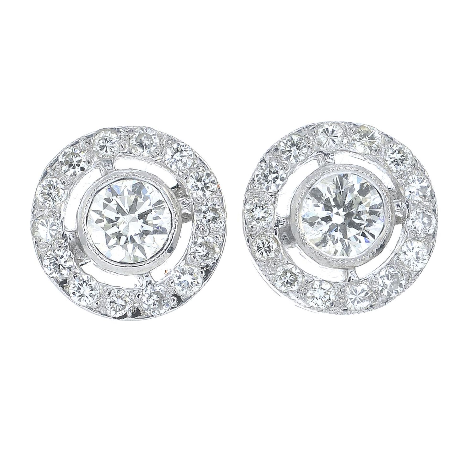 A pair of brilliant-cut diamond cluster earrings.Estimated total diamond weight 0.70ct,