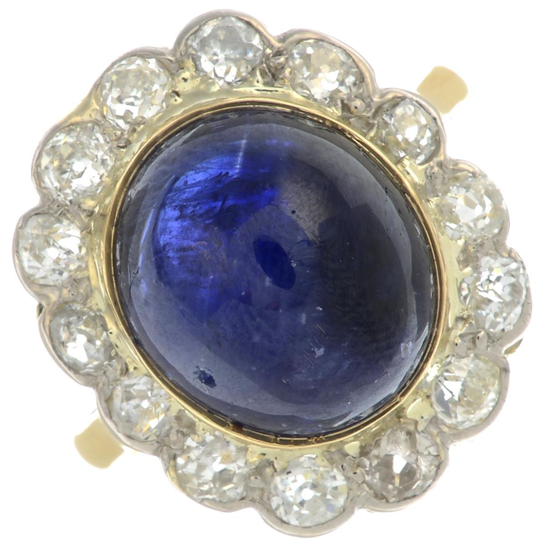 A sapphire cabochon and old-cut diamond cluster ring.Sapphire calculated weight 9.76cts,