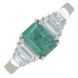 An 18ct gold emerald and diamond dress ring.Emerald weight 0.90ct.Estimated total diamond weight