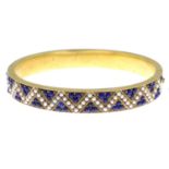 A late 19th century gold split pearl and lapis lazuli bangle,