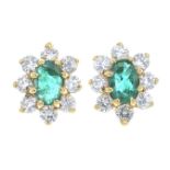 A pair of emerald and brilliant-cut diamond cluster earrings.