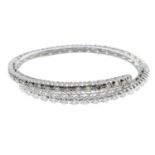 A brilliant-cut diamond and 'brown' diamond bangle.Estimated total brown diamond weight 1.25cts,