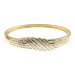 An 18ct gold vari-cut diamond hinged bangle.