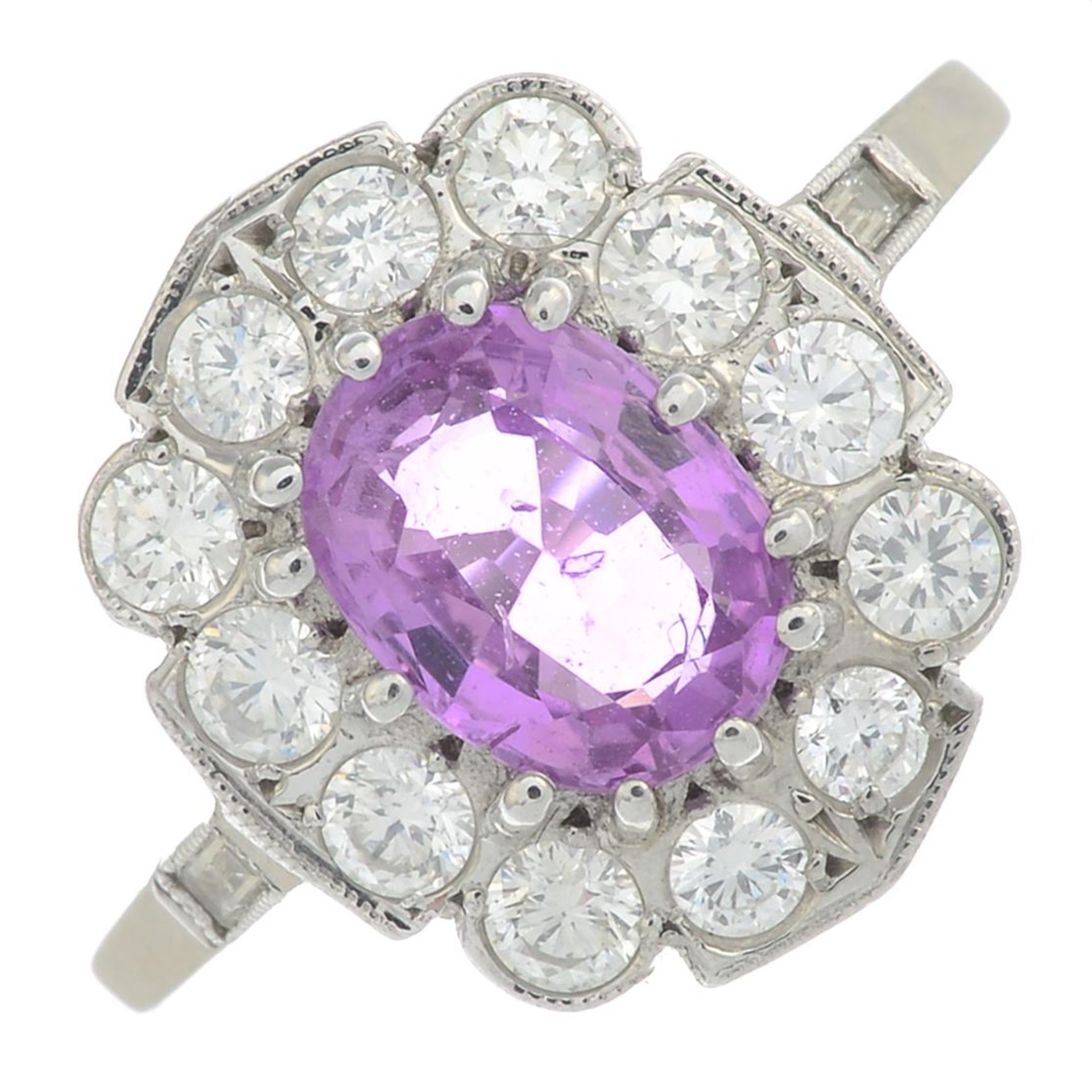 An oval-shape pink sapphire and brilliant-cut diamond cluster ring.