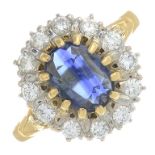 An 18ct gold oval-shape sapphire and brilliant-cut diamond cluster ring.Estimated total diamond