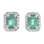 A pair of rectangular-shape emerald and brilliant-cut diamond cluster earrings.Total emerald weight