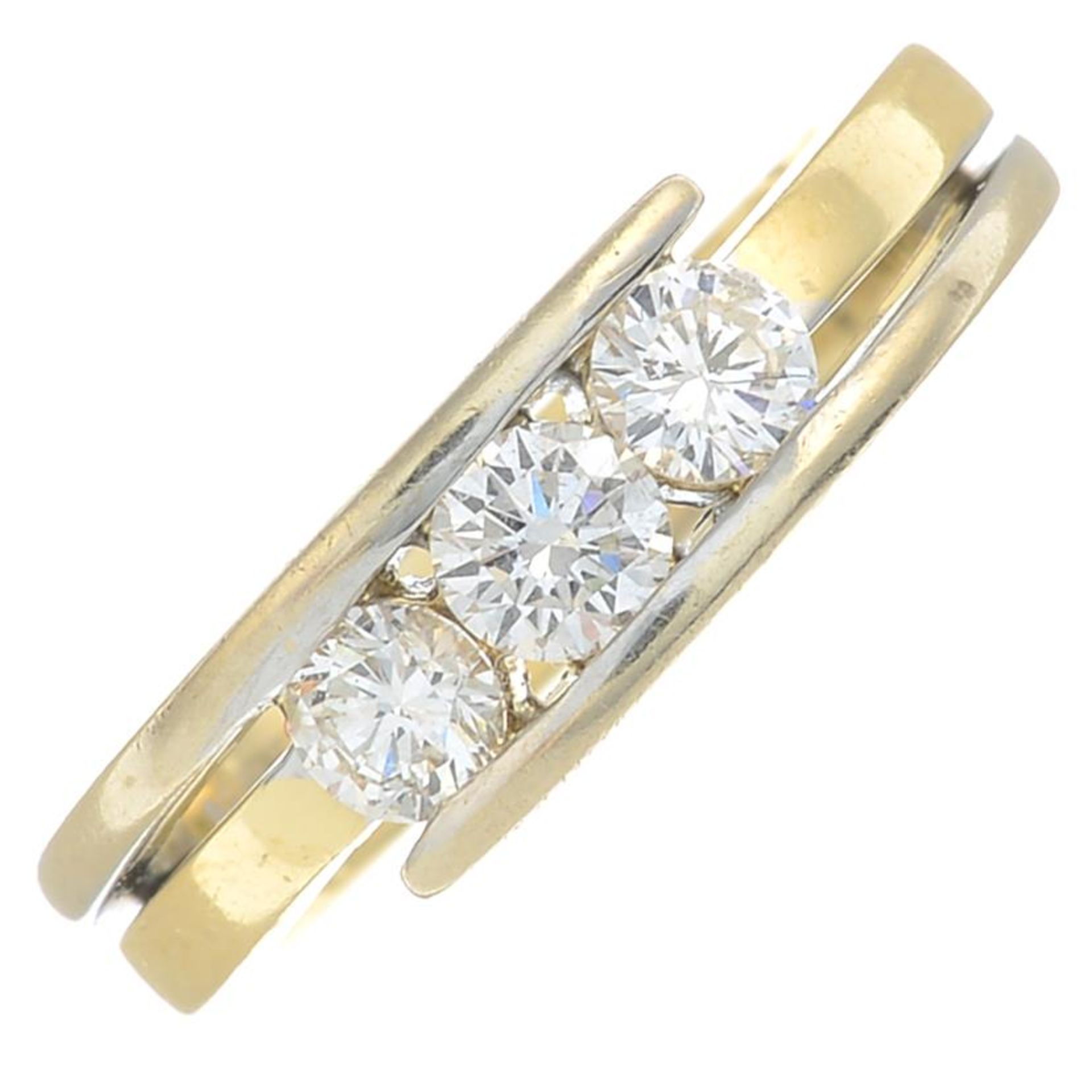 An 18ct gold brilliant-cut diamond three-stone ring.Estimated total diamond weight 0.60ct,