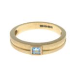 A 9ct gold blue topaz single-stone band ring.