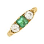 An early 20th century 18ct gold emerald and diamond three-stone ring.Estimated total diamond weight