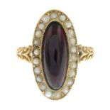 A late 19th century oval garnet cabochon and split pearl ring.Ring size N.