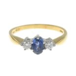 An 18ct gold diamond and sapphire three-stone ring.Total diamond weight 0.20ct, stamped to band.