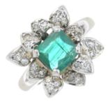 An emerald and diamond cluster ring.