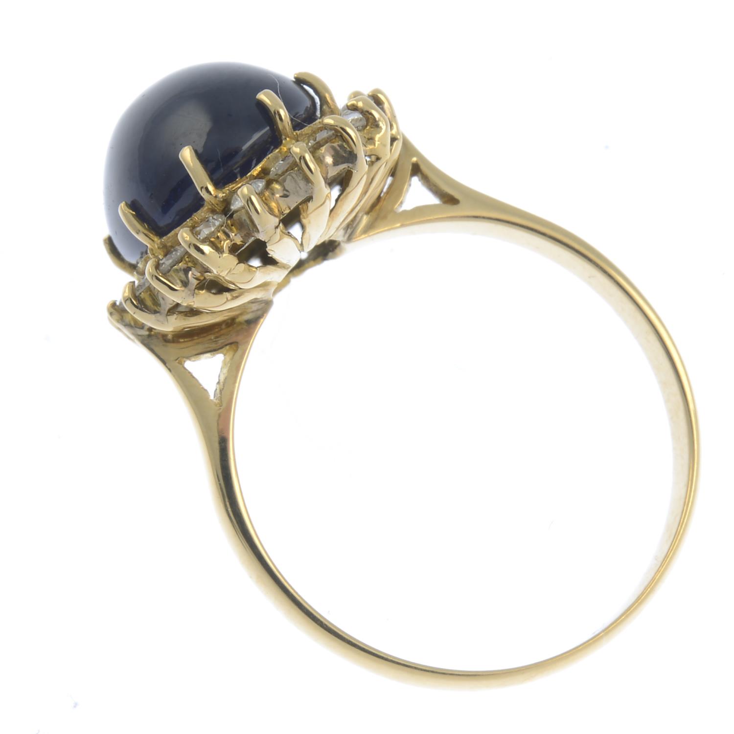 An oval sapphire cabochon and brilliant-cut diamond cluster ring.Estimated total diamond weight - Image 2 of 2