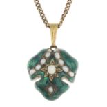 A green enamel and split pearl pendant, suspended from a curb-link chain.Length of pendant 3.4cms.