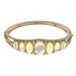 A late Victorian gold opal and old-cut diamond hinged bangle.