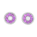 A pair of brilliant-cut diamond and pink sapphire floral cluster earrings.Estimated total diamond