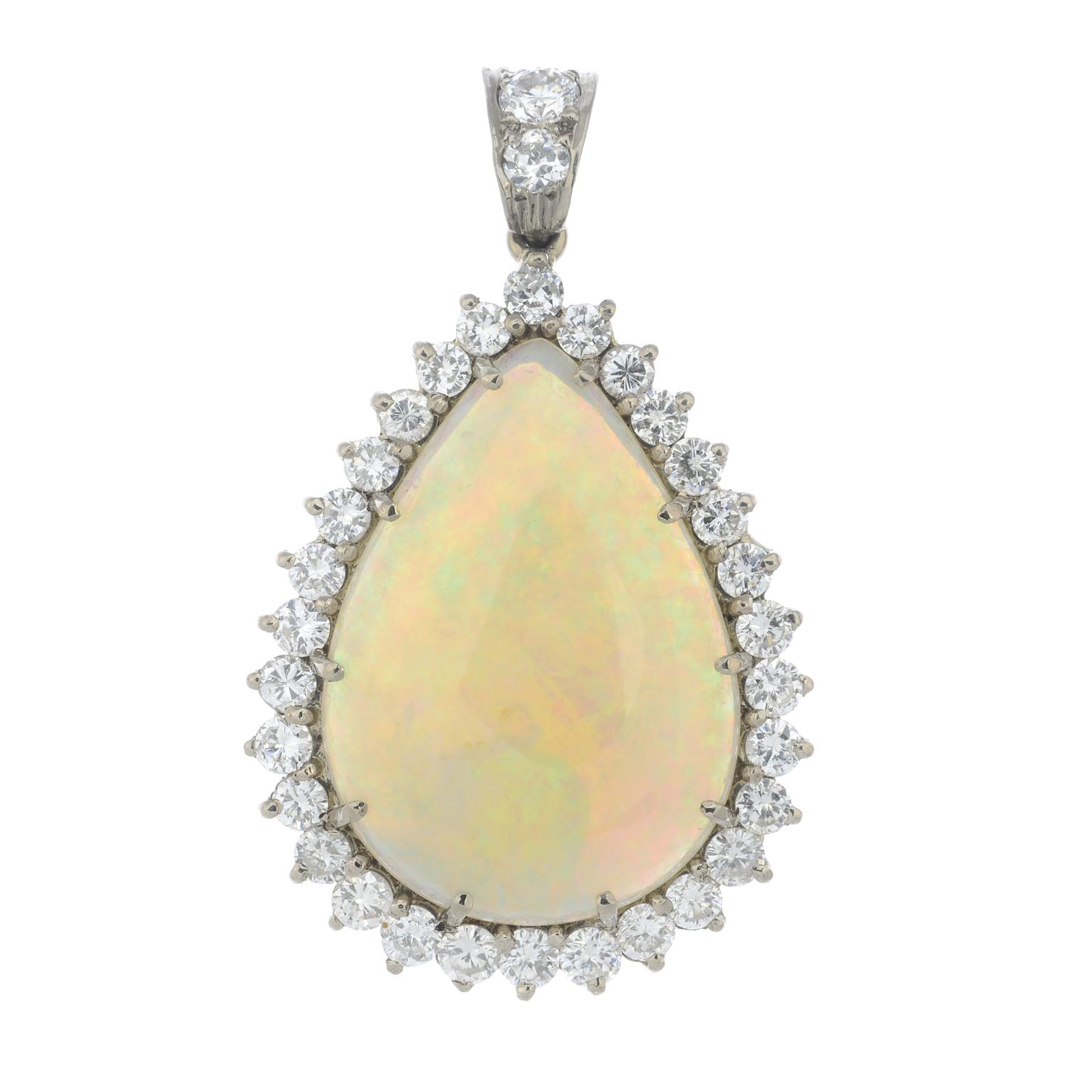 An 18ct gold opal and brilliant-cut diamond cluster pendant.Estimated dimensions of opal 23.3 by
