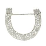 An early 20th century Belle Epoque platinum vari-cut diamond foliate horseshoe brooch.Estimated