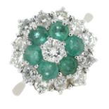 An brilliant-cut diamond and emerald double cluster ring.Estimated total diamond weight 1.20cts,