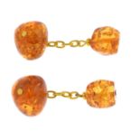 A pair of modified amber cufflinks.Lengths of cufflink faces 1 to 1.5cms.