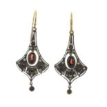A pair of garnet and diamond earrings.Estimated total diamond weight 0.15ct.